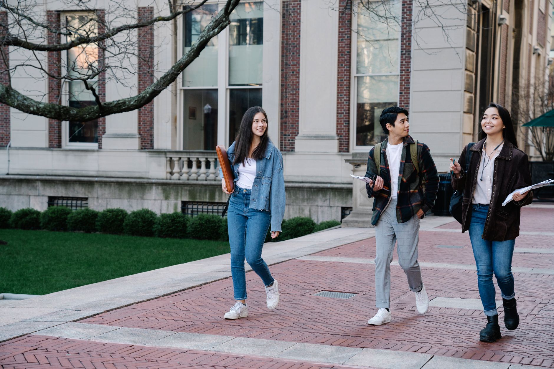 Students walking across a university campus in Sydney, representing the on-campus study environment for the applied degrees